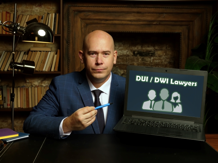Business concept meaning DUI DWI Lawyers with sign on card in hand