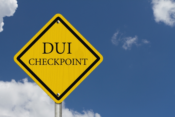Stop Drinking and Driving, An American road warning sign with words DUI Checkpoint with blue sky