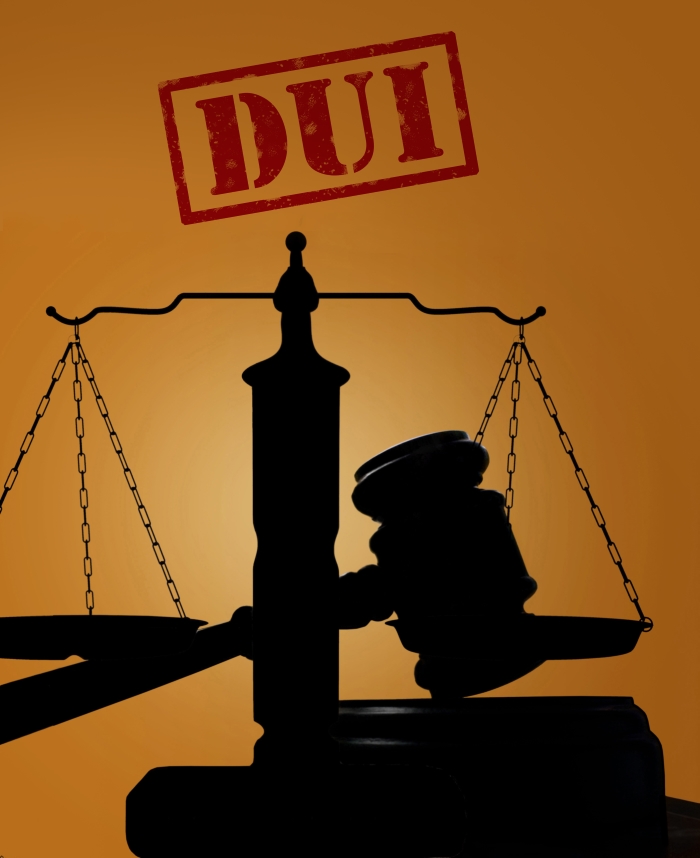 Court gavel and scales of justice silhouette with DUI stamp. Driving under the influence concept